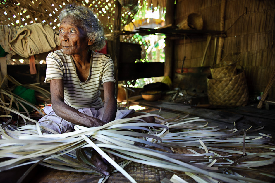 Mamanwa elder weaving a banig mat.